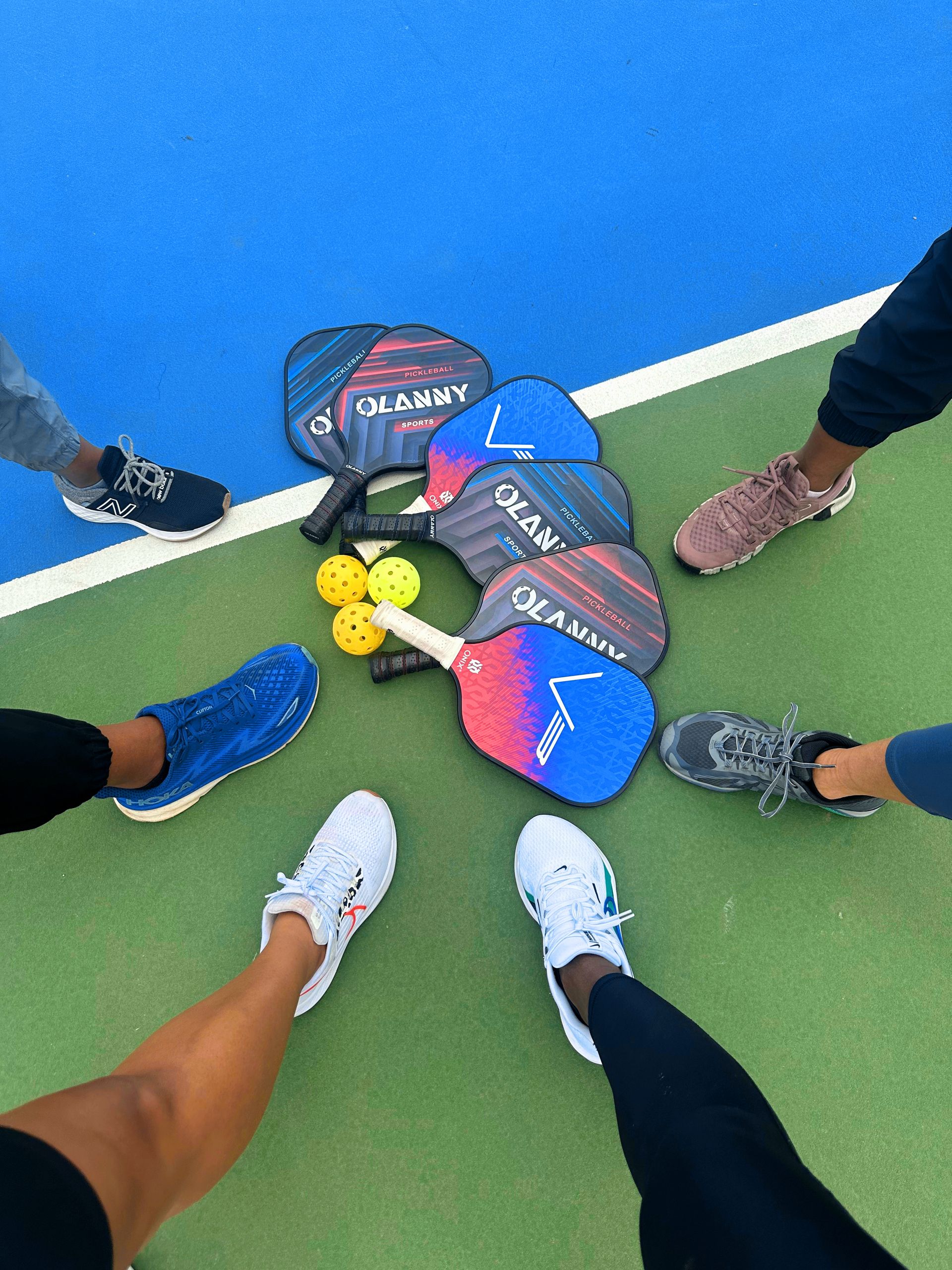 Group of people preparing for pickleball game on a court in St. George, UT.